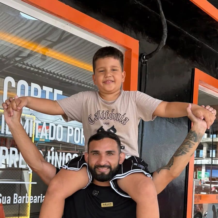 Dênis e o pequeno cliente na porta da barbearia